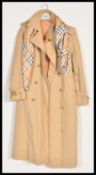 A Vintage 20th Century ladies Aquascutum  belted raincoat trench mac together with a 20th Century