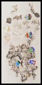 A vintage 20th Century stamped sterling silver charm bracelet having a large collection of