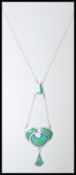 A stamped 925 silver necklace having an art nouveau style pendant with green enamel panels. Weight