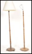 Two vintage mid 20th Century floor standing standard lamps, raised on circular footed base, turned