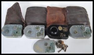 A selection of four early 20th Century bookies 'The Tic Tac' timed lock safe bags, made by the