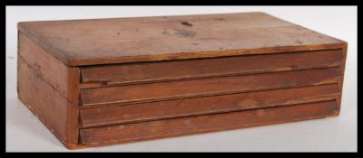 A vintage 20th century wooden case of watch parts full of different sized crown winders installed