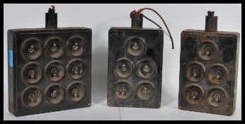 A collection of three vintage 20th Century industrial tin plate and cast iron light switches, the