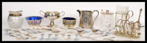 A collection of silver plated items dating from the 19th Century to include a toast rack, preserve