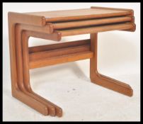 A mid 20th century Danish influence nest of teak tables. Each of graduating form with shaped legs