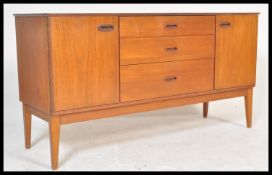 A vintage retro 20th century teak sideboard having a bank of three central drawers flanked by