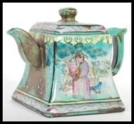 A 19th Century Chinese Yixing pottery teapot of square form having hand painted cartouche panels