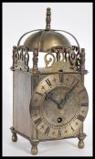 A 19th Century Victorian lantern clock having a pierced frieze with bell to top. The silvered dial