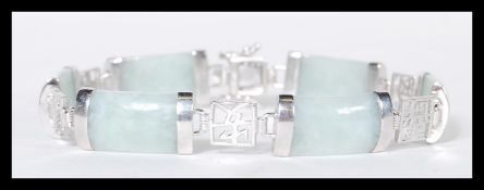 A sterling silver Chinese jade panel bracelet having jade cabochon and silver character mark spacers
