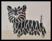 A stamped 925 silver plique a jour brooch in the form of a scottie dog having oval cut ruby eyes.