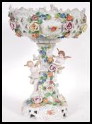 A 20th Century German china centrepiece in the manner of Sitzendorf / Dresden having pierced