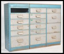 A vintage 20th Century industrial metal filing cabinet having three banks of graduating drawers