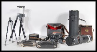 A collection of vintage 20th Century cameras to include a Vauxhall folding bellows camera, cased