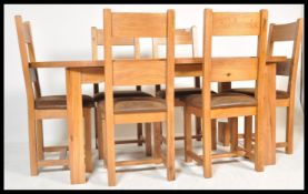 A contemporary large extendable oak dining table in the manner of Oak Furniture land  together