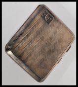 An early 20th Century hallmarked silver cigarette case by E J Trevitt & Sons of rectangular form