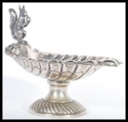 An early 20th Century silver plated electroplated Nut Dish The scallop-shaped bowl with embossed