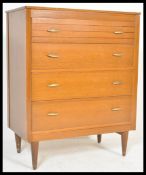A vintage mid 20th Century oak modernist chest of drawers. The bank of four drawer having
