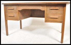 A mid century Air Ministry style oak twin pedestal desk raised on squared legs with a series of