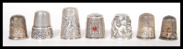 A group of seven hallmarked silver and sterling silver 925 decorative thimbles to include a relief