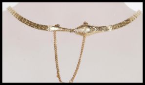 A stamped 9ct gold Art Deco Ouroboros choker necklace in the form of a serpent / snake having a flat