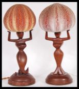 A pair of fantastic retro 1950's - mid 20th Century teak bedside table lamps, the lamps modeled as