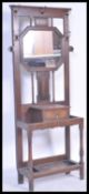 An early 20th century Edwardian oak wall mounted hall coat stand, having an octagonal bevelled