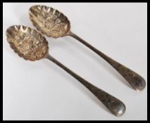 A pair of Edwardian silver hallmarked Walker and Hall berry spoons. Sheffield assay marks and dating