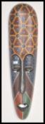 A large 20th Century Australian Aboriginal carved tribal wall mask having detailed features and