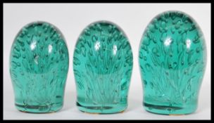 A collection of three 19th Century Victorian Nailsea Glass paperweights or dumps, each paperweight