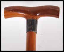 A 20th Century walking stick cane of tapering form having a silver hallmarked silver collar below