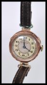 An early 20th Century hallmarked 9ct gold watch having a silvered dial with mother of pearl