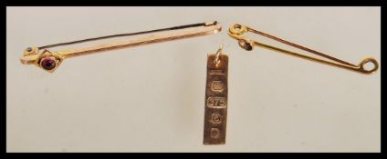 A hallmarked 9ct gold ingot pendant along with two stamped 9ct gold Victorian bar brooches one being