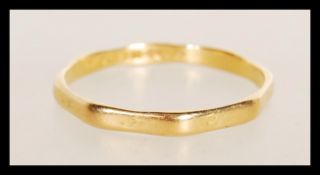 A 22ct gold Birmingham hallmarked octagonal band ring. Total weight 2.6g / Size X
