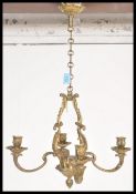 A 20th Century bronze candelabra having four candle sconces with scrolled acanthus leaf