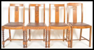 Four vintage mid 20th Century oak dining chairs, raised on barley twist legs with carved floral