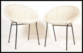 A pair of retro vintage 20th Century Lloyd Loom atomic satellite chairs, raised on metal supports