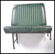 Two vintage mid century Industrial original bus / coach seats being raised on the tubular black
