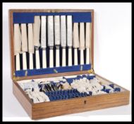A vintage early 20th Century oak cased canteen of cutlery having a six person setting. The oak
