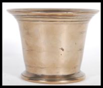An 18th Century Georgian bronze bowl or mortar of conical form having glared stepped rim. Measures