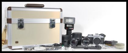 A vintage Pentax K 1000 film camera along with associated equipment to include a Pentax 1:2 50mm