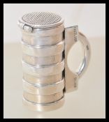 A stamped 925 silver vesta case in the form of a tankard having a hinge lid with striker. Weight