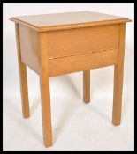 A vintage 20th Century oak sewing work box table, hinged top opening to reveal appointed interior