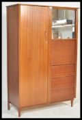 A retro mid 20th Century teak wood compactum / bachelors wardrobe,  full length door to the left