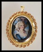 An 18ct gold / 750 marked portrait necklace pendant. The portrait miniature with inset diamonds