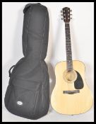 A 20th Century Fender six string acoustic guitar model DG-5 NAT having a shaped hollow body with