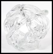 A 20th Century retro studio art glass sculpture in the form of a knot. The sculpture of clear