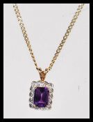A 14ct gold curb link necklace chain having a hallmarked 9ct gold amethyst and diamond set