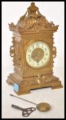 A 19th Century Victorian gilt brass mantel clock raised on a bracket base with armorial decoration