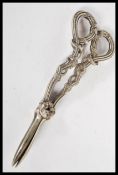 A pair of 19th century silver plated grape scissors along with a stamped solid silver toothpick with