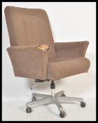 A vintage 20th century office desk chair raised on a central column with four splayed legs and
